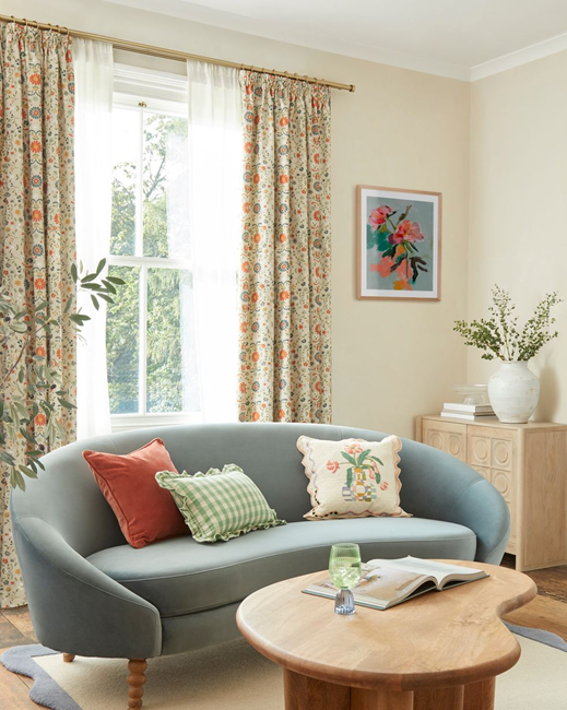 make-a-small-living-room-look-bigger-by-using-natural-light-and-blue-curved-sofa
