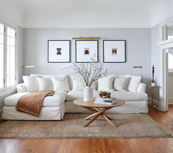 slipcovered-sectional-styled with-a-brown-throw-blanket